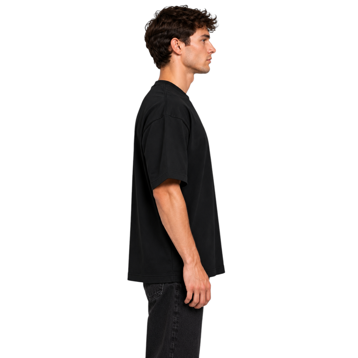 DAWIS Core black oversized cotton t-shirt with a relaxed fit worn by a man in a side profile view